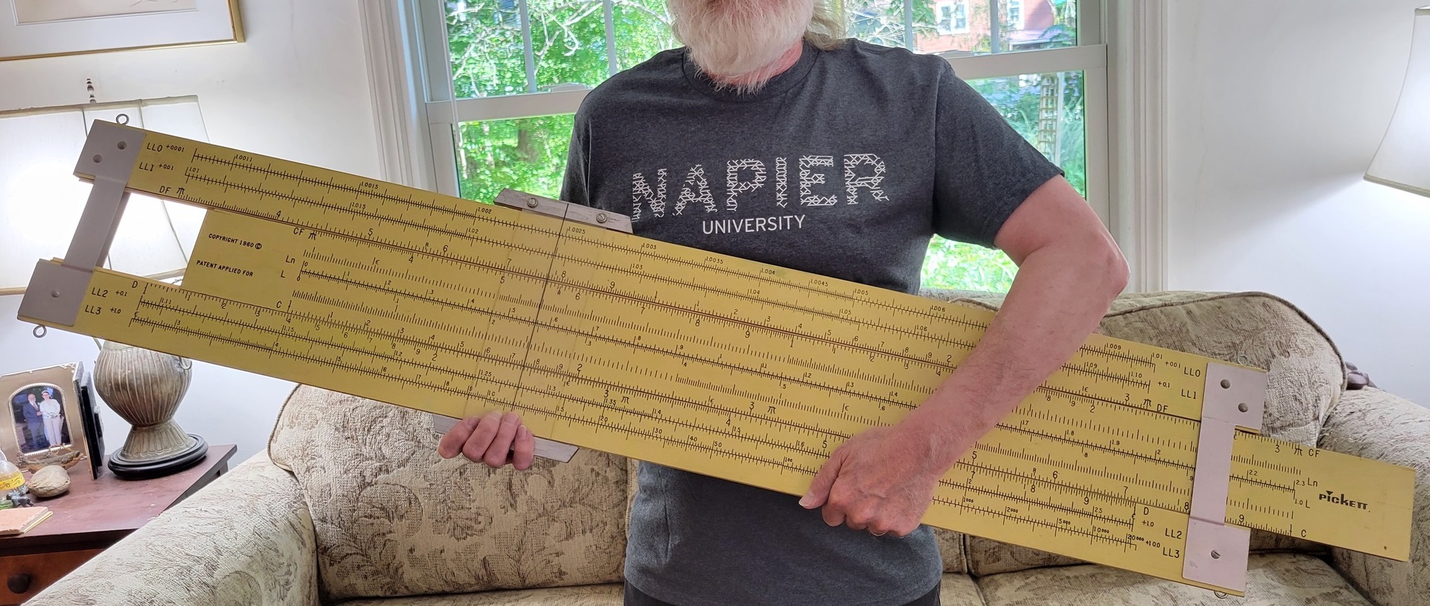 Charles Petzold holding massive slide rule